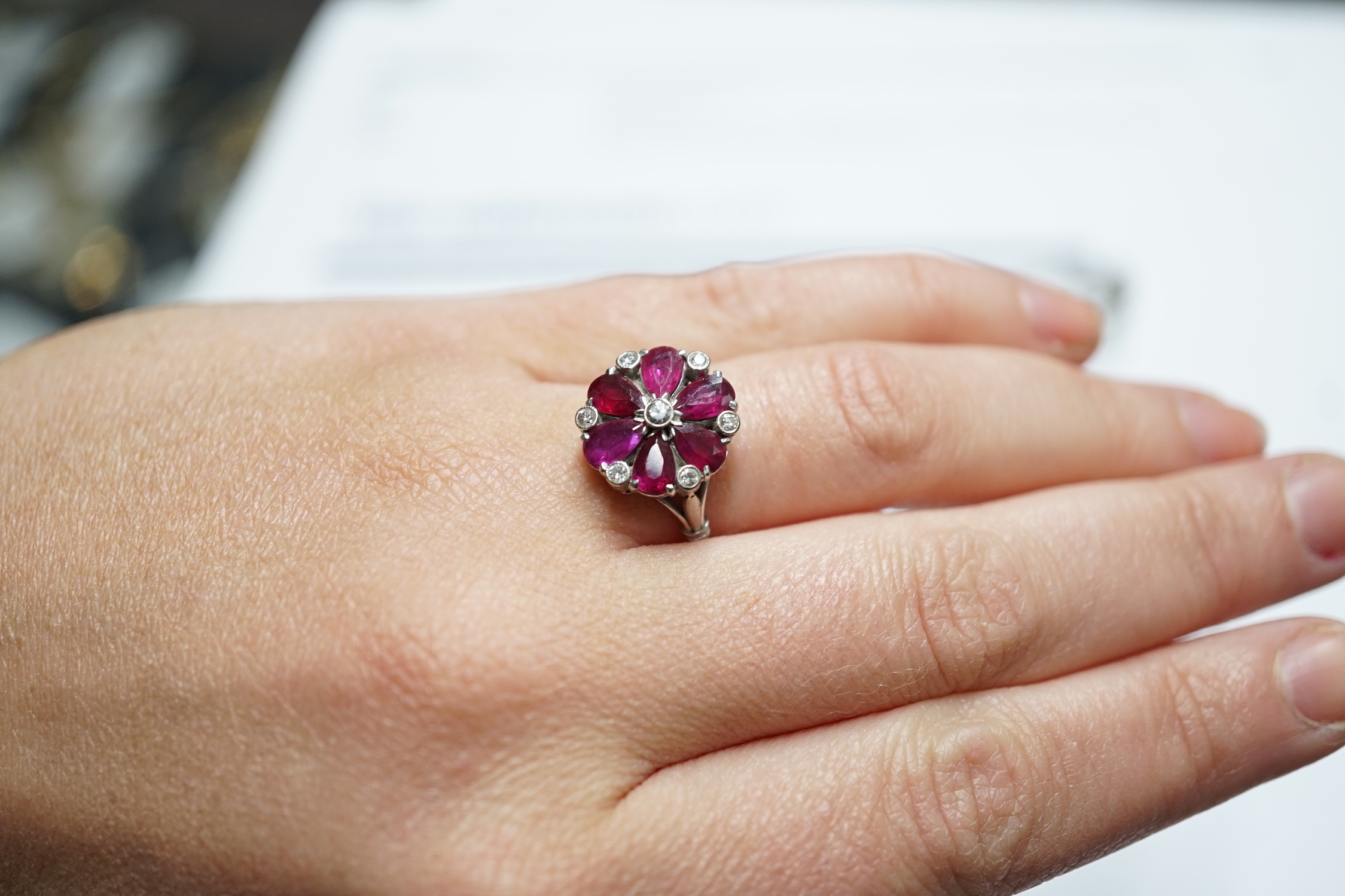 An 18ct & plat, pear cut ruby and diamond chip cluster set ring, size N/O, gross weight 4.8 grams.